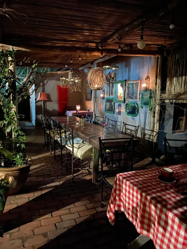 Outdoor evening dining area at Abbiocco with long table and lantern lighting
