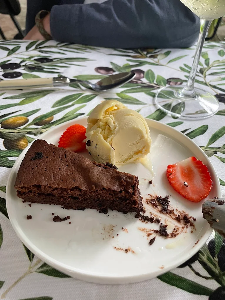 Torta Caprese slice served with home churned ice cream and strawberries