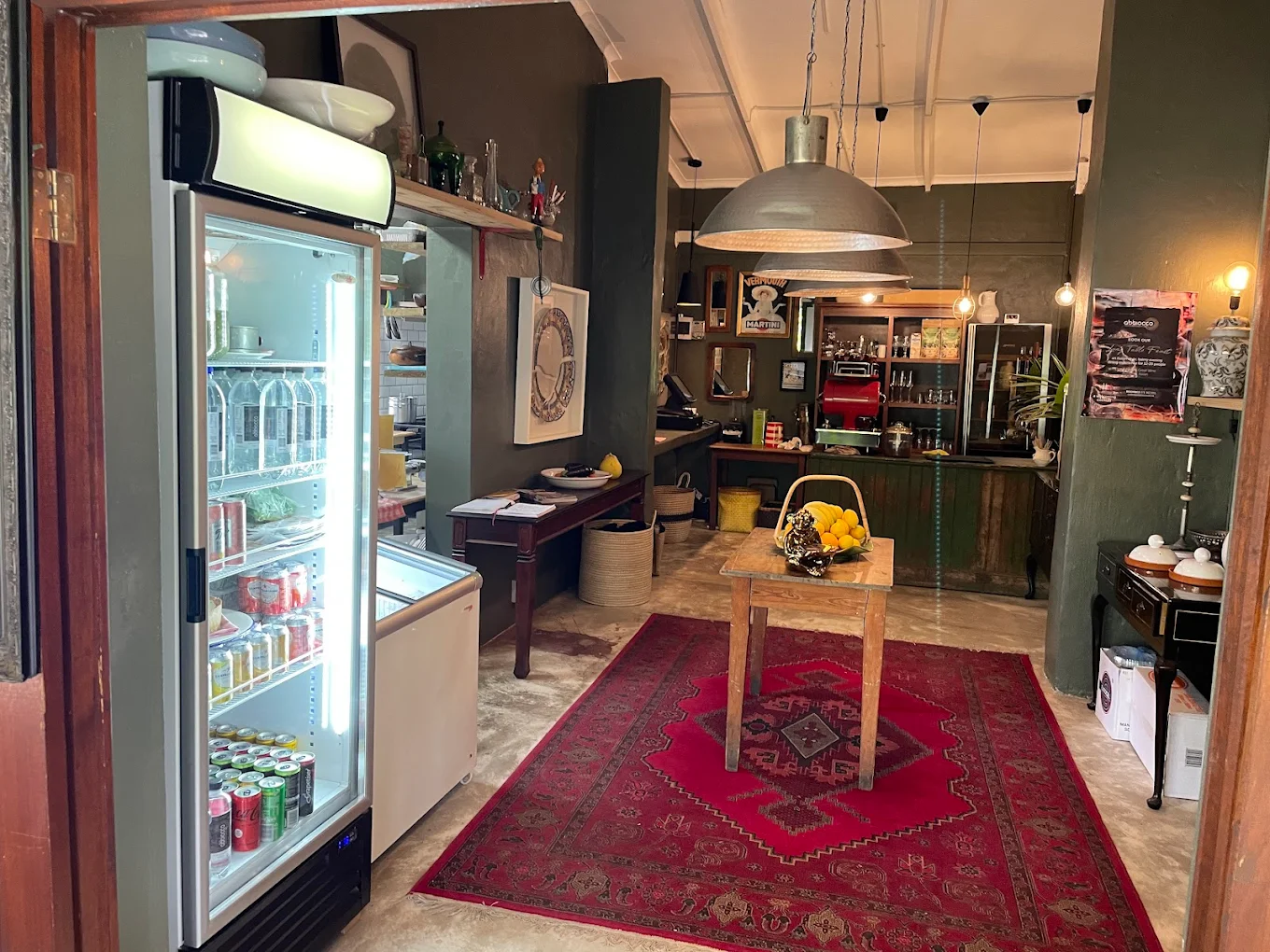 Inside Abbiocco with deli fridge, warm lighting and welcoming entrance